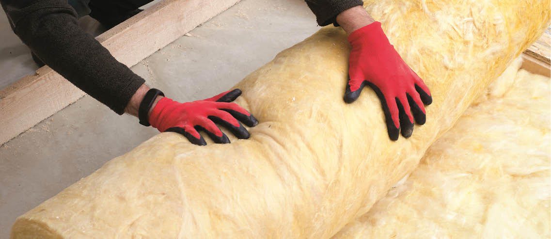 Caucasian Construction Worker with Roll of Insulating Material, Floor Insulating by Mineral Wool.; Shutterstock ID 774345898; PN: Aerolite/ Isover