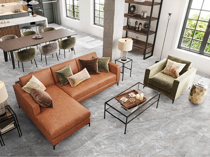 Modern apartment open plan living room interior. Large leather sofa, velvet armchair, coffee table, pillows, lamp, carpet, concrete pillars, window and dining room in the background. Copy space template. Render.