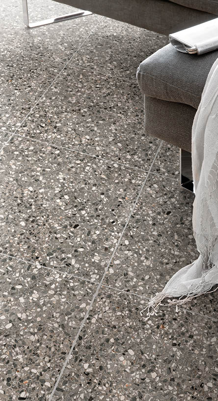 Women's shoes and clothes lying in front of a sofa